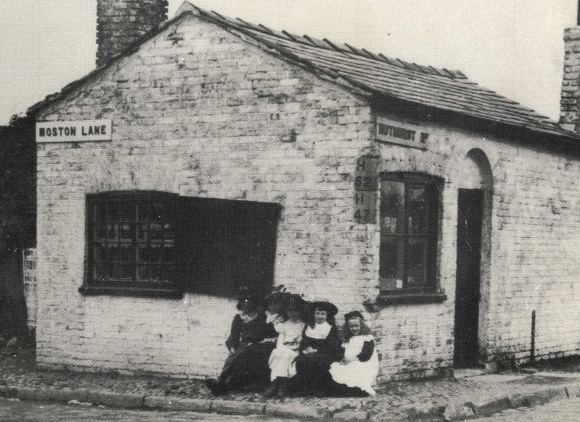 Old photograph of young girls outside a shop, Moston Lane